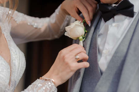 Boutonniere on the grooms jacket. Flower on a mans jacketの写真素材