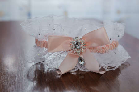 Bride's garter on the bride's leg. Garter on the girl's legの写真素材