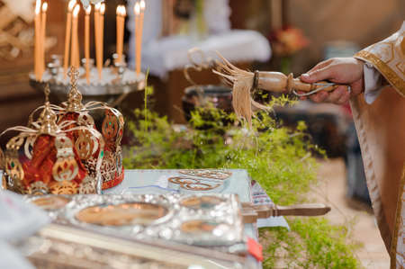 A pair of gold wedding rings on a heart-shaped stand