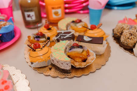 Sweet cakes at a wedding banquet. Catering, sweet festive buffet
