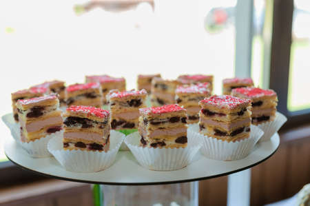 Sweet cakes at a wedding banquet. Catering, sweet festive buffet