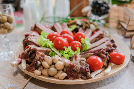 Slicing different types of meat. Meat snacks on the table. wedding buffetの写真素材