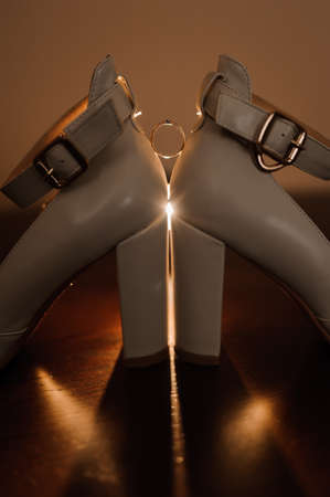 Bride's shoes, gold wedding ring with diamondの写真素材