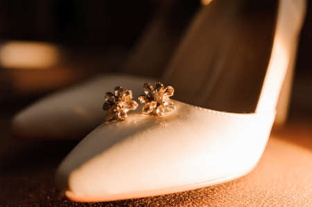 Wedding accessories: wedding shoes, earrings with yellow stonesの写真素材