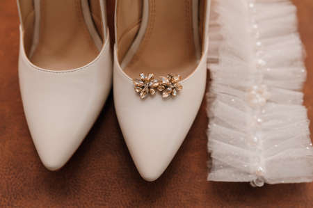 Wedding accessories: wedding shoes, earrings with yellow stones