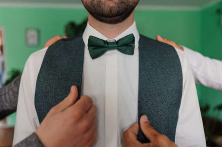 Green bow tie around the neck of a man. Weddingの写真素材