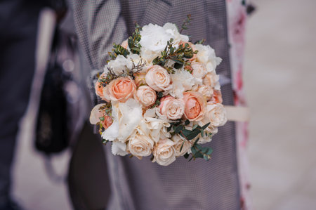 A bouquet of flowers in the hands of the bride. A bouquet of colored flowers in the hands of a girl.の写真素材