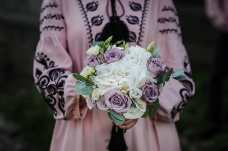 A bouquet of flowers in the hands of the bride. A bouquet of colored flowers in the hands of a girl.の写真素材