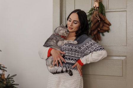 Gray cat in the arms of a pregnant womanの写真素材