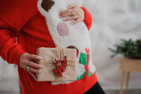 Pregnant woman holding her hands on her bellyの写真素材