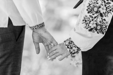 The boy and the girl walk holding hands. Man holding woman's hand.の写真素材
