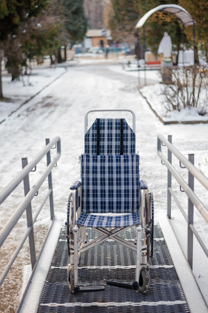 Empty wheelchair in the hospital on the ramp. Wheelchair close-up. Children's wheelchair.の写真素材