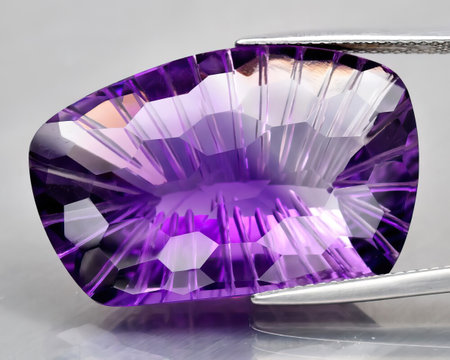 Natural gem purple amethyst on gray backgroundの写真素材