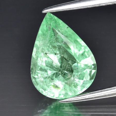 Natural gemstone green tourmaline on gray backgroundの写真素材