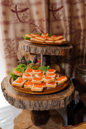 Small canapes with red caviar on the holiday buffetの写真素材
