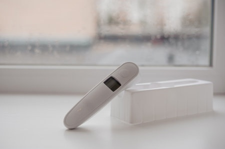 Non-contact thermometer on a background for measuring body temperature