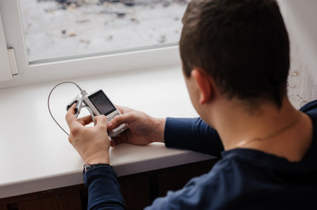 Man using finger pulse oximeter, healthcare monitoring concept. Pulse oximeter on a background