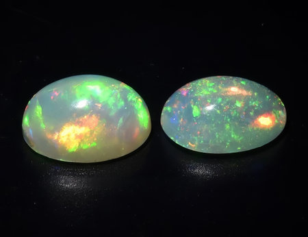 Natural precious stone noble opal on a black background