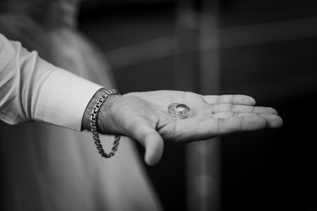 Wedding rings on the hands of the newlyweds. Gold rings on the hand of a man and a womanの写真素材