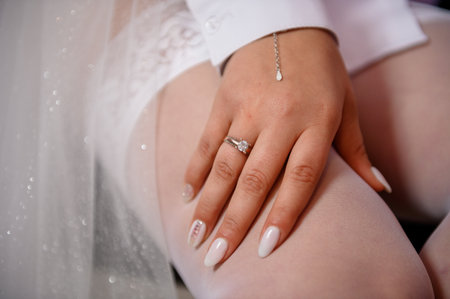 Gold ring with a diamond on the bride's hand. Ring with a stone on a woman's hand.の写真素材