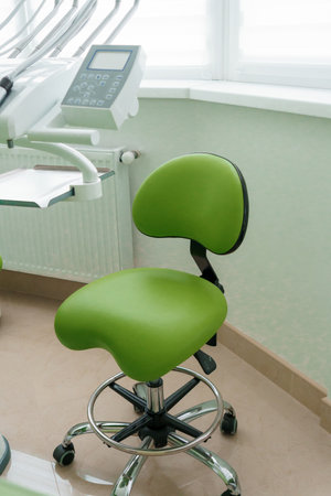dental office. Dentist's tools for dental treatment. The workplace of the dentist in the clinic. Dentist's green chairの写真素材