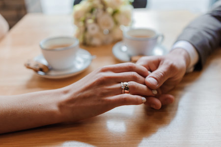 Golden wedding rings on the hands of the newlywedsの写真素材