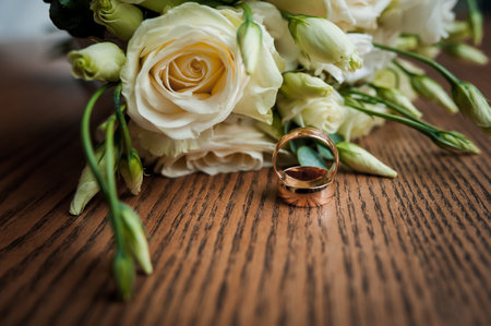 Two gold wedding rings on a brown backgroundの写真素材