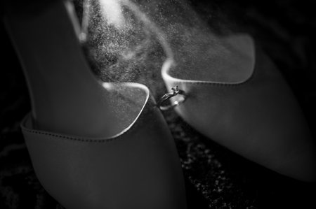 Gold ring with diamond on white women's leather shoesの写真素材