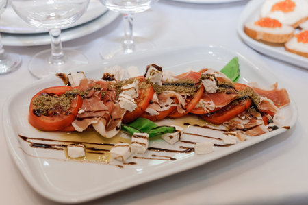 Slicing different types of meat. Meat snacks on the table. wedding buffet. Cateringの写真素材