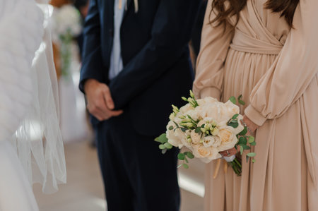 A beautiful wedding bouquet in the hands of the bride. A bouquet with white roses in the hands of the brideの写真素材
