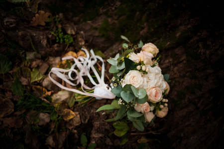 Beautiful wedding bouquet on a wood background. Bride's bouquet with white rosesの写真素材