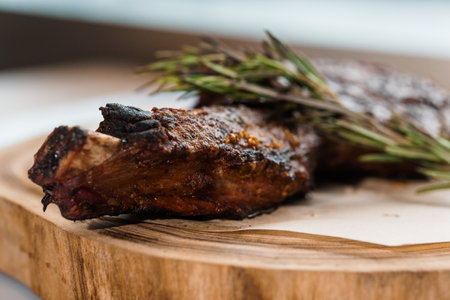 Pork steak with sauce on a wooden board on a white backgroundの写真素材