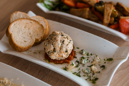 Cheese balls with herbs on a white backgroundの写真素材