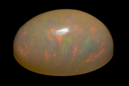 natural rainbow opal gem isolated on the black background