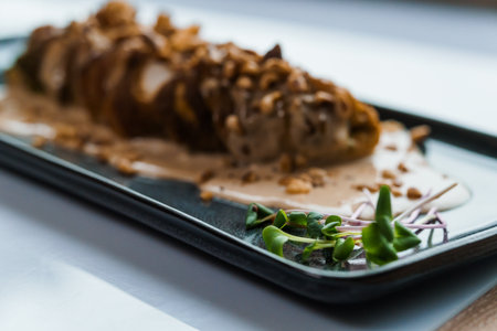 Stewed meat in mushroom sauce and herbs on a ceramic plateの写真素材