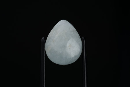 Exquisite Teardrop Aquamarine Gemstone Against a Black Background.