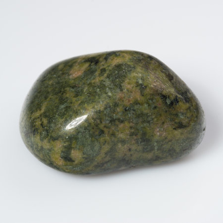 Vibrant Serpentine Gemstone with Smooth Polished Surface on a Subtle White Background.の写真素材