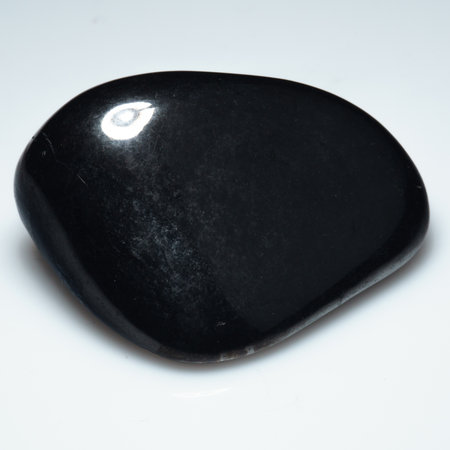 Elegant Shungite Gemstone on Pristine White Surface.