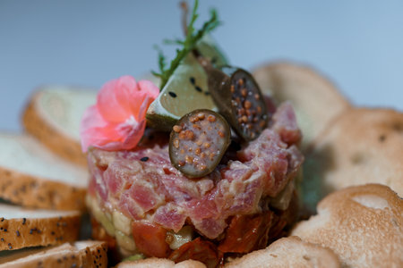 Exquisite Gourmet Tuna Tartare with Artisan Bread and Elegant Garnishes.の写真素材