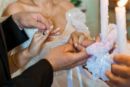 Intimate Wedding Ceremony Candle Ritual with Bride and Groom Exchanging Rings.の写真素材