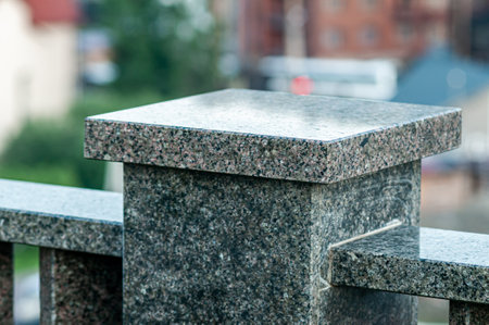Close-Up of Granite Stone Pillar with Urban Background.の写真素材