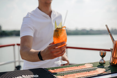 Refreshing Summer Cocktail Served by Bartender on a Scenic Rooftop Bar with a Beautiful View.