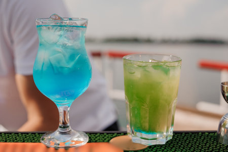 Refreshing Summer Cocktails on a Vibrant Outdoor Bar Setting.の写真素材