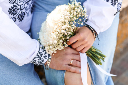 Elegant Bouquet of White Flowers in a Soft Embrace with Traditional Embroidery.の写真素材