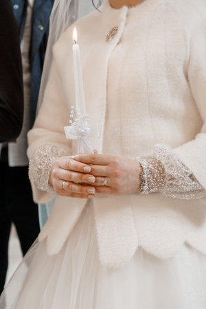 Elegant Bride Holding a Candle in a Blessed Ceremony.