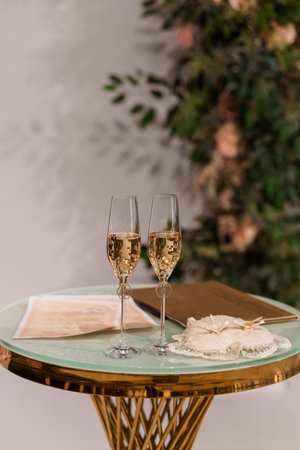 Elegant Celebration Setting with Sparkling Champagne on a Stylish Table Decorated with Floral Background.の写真素材