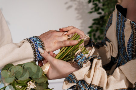 Elegant Hands Intertwined with Greenery and Traditional Textile Patterns.
