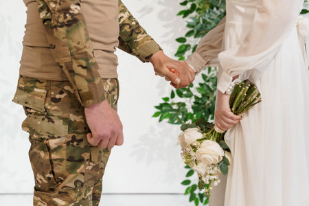 Emotional military wedding: Love blooms amidst service and sacrifice.の写真素材