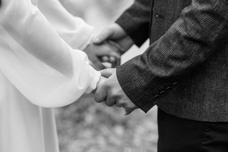 Romantic Black and White Close-up of a Couple Holding Hands in Nature.の写真素材