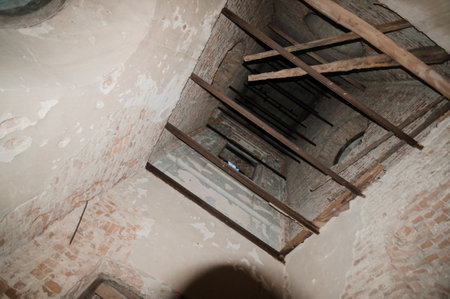 A Mysterious Abandoned Tower Interior with Exposed Beams and Weathered Walls.
